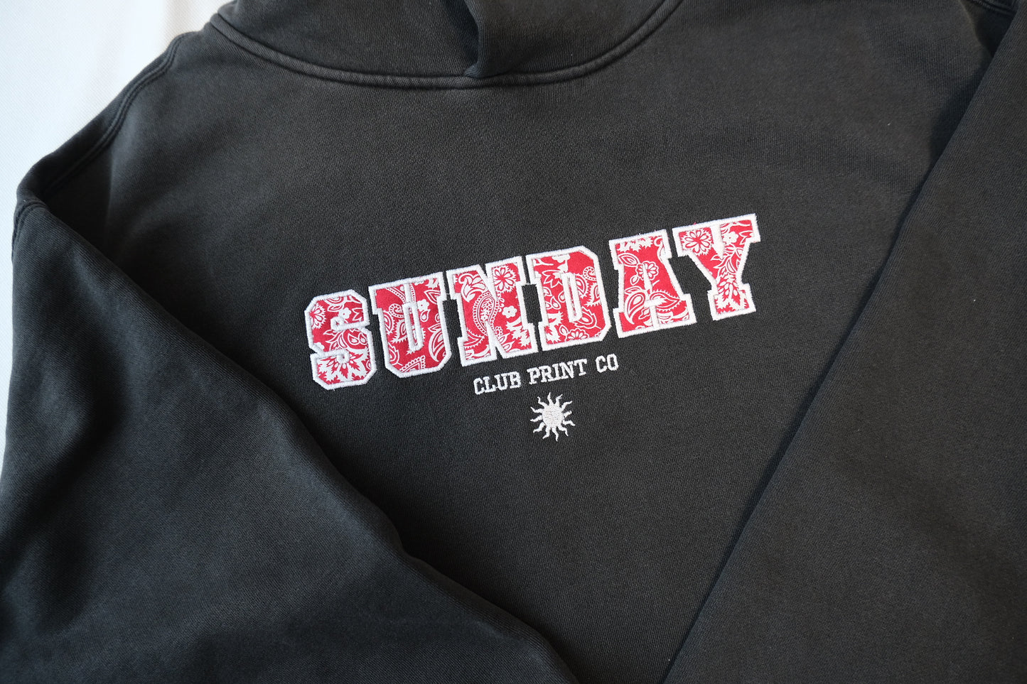 Sunday Club Embroidered Varsity Hoodie in Faded Black.